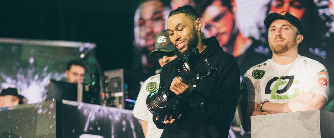 Halo professional aPG holding trophy on stage after winning 